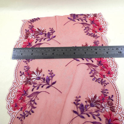 red galloon lace with  red flowers, purple leaves and white embroidery at the edges . Ruler shows it as 23 cm width