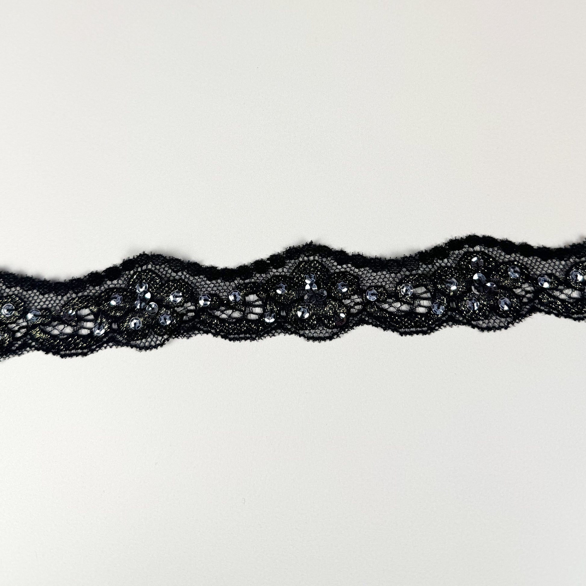 Black lace trim on a light background